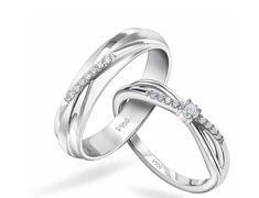 two white gold wedding rings with diamonds on each one and the other in between them