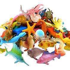 a bunch of toys that are in the shape of sea animals and fish on a white background