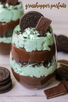 an oreo cookie dessert in a glass with mint green frosting and chocolate chips