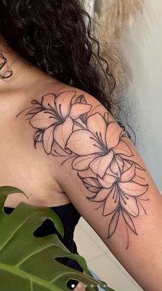 a woman with a flower tattoo on her shoulder