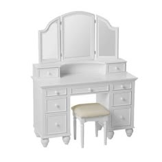 a white vanity with mirror and stool