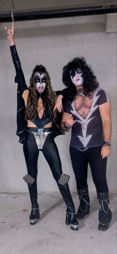 two people dressed up as kiss band members