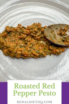 roasted red pepper pesto on a white plate with a spoon and text overlay reads roasted red pepper pesto