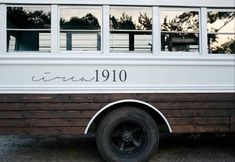 an old school bus is parked on the side of the road