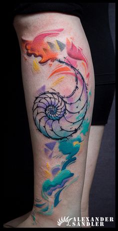 a woman's leg with colorful tattoos on it