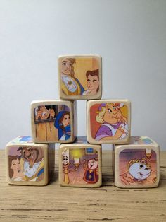 the wooden blocks have pictures of disney characters on them, and are stacked up together