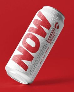 an unopened can of soda on a red background