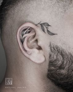 a man's ear with leaves on it