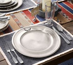 a table set with silverware and place settings