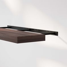 a wooden shelf with metal brackets attached to it