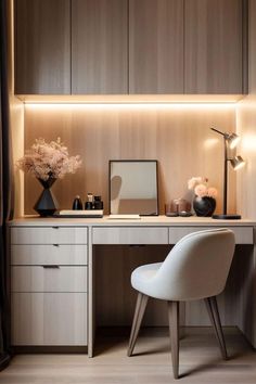 a white chair sitting in front of a desk with a mirror and lamp on it