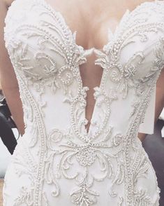 the back of a wedding dress with beading on it