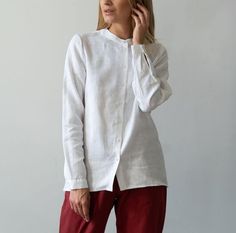 Experience chic elegance with our long sleeves classic blouse, tailor-made for the fashion-forward woman. This collarless design embodies a minimalist aesthetic, setting you apart with its understated charm. Crafted from premium linen, this top is not only stylish but also ensures comfort, making it an ideal pick for all-day wear. Its versatile nature pairs seamlessly with a variety of outfits, be it jeans or formal trousers. Dive into the world of contemporary fashion with this must-have linen top. * Made from washed European blend linen (60% linen and 40% cotton) * OEKO-TEX certified fabric (no harmful chemicals used in production) * No chest folds, straight original fit * Long sleeve * From XS to Plus size TAKING CARE: * machine wash gentle (30- 40 C/ 104 F) * dry gentle. * do not bleac Classic Blouse, Linen Shirts Women, Natural Clothing, Classic Blouses, Formal Trousers, Button Down Blouse, Minimalist Aesthetic, Shirt For Women, Harmful Chemicals