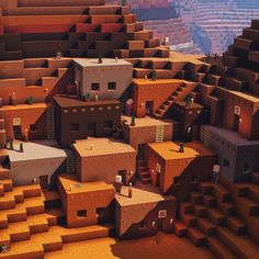 an aerial view of some houses in the desert with stairs leading up to them and people standing outside