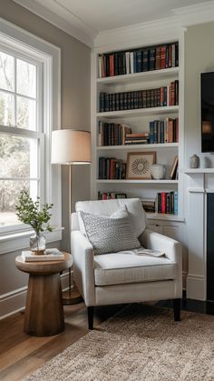 a living room with bookshelves and a couch in front of a fire place