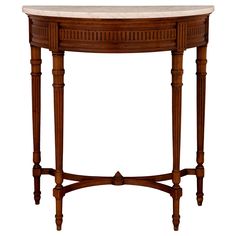 an oval wooden table with marble top