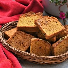 a basket filled with slices of bread next to a potted plant