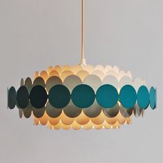 a light that is hanging from a ceiling with circles on the top and bottom of it