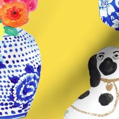 a dog figurine sitting next to two vases with flowers on them in front of a blue background