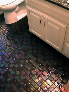 a bathroom with a toilet, sink and tiled floor in it's own area