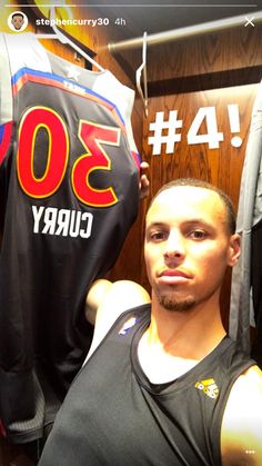 a man standing in front of a shirt that says 30 curry on it and the number thirty