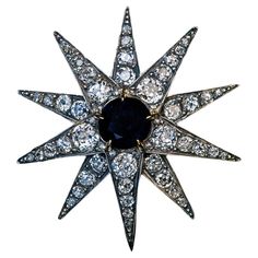 Circa 1890s – early 1900s The ten pointed star with a raised center is handcrafted in silver and 14K gold. It is centered with a round midnight blue sapphire (approximately 2.64 ct). The rays of the star are embellished with sparkling bright white old mine cut diamonds (mostly F-G-H color, VS-SI clarity). The diamonds are set in silver over gold. Estimated total diamond weight is 3.70 ct. Width 41 mm (1 5/8 in.) The star has a detachable pin and can be worn as a pendant. Sold without chain. Victorian Pendant Necklace, Diamond Centerpiece, Star Brooch, Victorian Pendants, Gold Fronts, Cultured Pearl Necklace, Diamond Brooch, Diamond Star, Gold Brooches