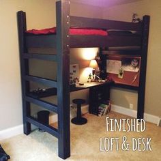 a loft bed with desk underneath it