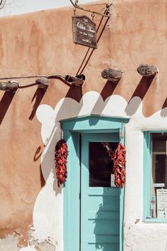 a blue door and window in front of a building