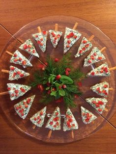 a platter filled with pizza on top of a wooden table covered in toppings