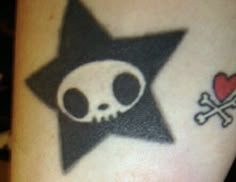 a star with a skull and crossbones on the side of someone's arm