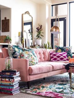 a living room filled with lots of furniture and decor on top of a rug covered floor