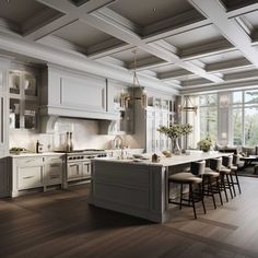 a large kitchen with white cabinets and wood flooring is pictured in this image, there are several stools around the island