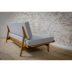 a gray couch sitting on top of a wooden floor