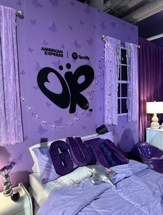 a bedroom with purple walls and curtains on the wall is decorated in an american express theme