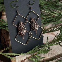 Glam up your look with these hand-sculpted copper pinecone earrings! Perfectly shiny and stylish, you'll stand out like a pine in a forest with these geometric brass-accented beauties. Put 'em on and make 'em stare! Copper Pinecone, Pinecone Earrings, Pine Cone Jewelry, Glam Jewelry, Witch Vibes, Green Witch, Soft Bristle Brush, Copper And Brass, Resin Earrings