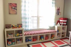 a child's playroom with toys and bookshelves in the corner,