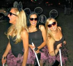 three women dressed up in costumes and posing for the camera with their canes on