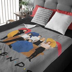 a bed covered in a blanket with the tv show friends on it's side