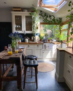 a kitchen filled with lots of counter top space next to a dining room table and chairs