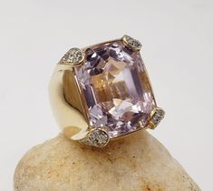 .. Title Rectangle Kunzite and Diamonds Ring in 14KT Yellow Gold Size 6.5 US Designer Unbranded Material Yellow Gold                      14 KT Stamped Style Vintage Gemstone Details   All measurements are approximate and may vary slightly from the listed dimensions. Kunzite 29.43 CT estimated 18.88 x 14.76 x 12.30   64 Stones Diamonds Single cut 0.64 Approx   Clarity G-H  Color SI3 to I1         Estimated Measurements Length/Width/Depth   Size 6.25 US Estimated  Total Weight  Dwt: 16.5   Grams: Moon Flower, Victorian Jewelry, Jewelry Inspo, Diamond Rings, Jewelry Inspiration, Jewelry Watches, Jewelry Rings, Fine Jewelry, Yellow Gold