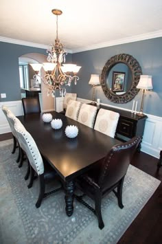 a dining room table with chairs and a chandelier