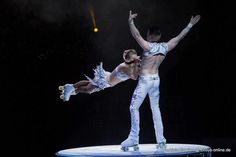 two dancers performing on top of a trampoline