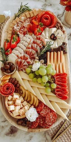 an assortment of cheeses and meats on a platter