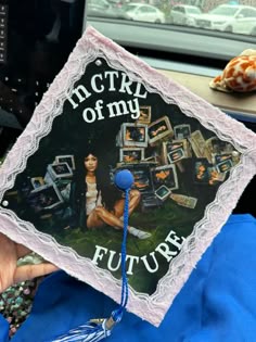 a person holding up a graduation cap with pictures on it