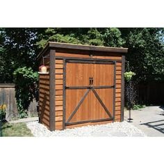 a large wooden shed with an open door on the front and side doors are closed