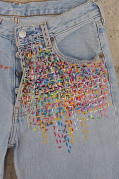 a pair of jeans with colorful sequins on them