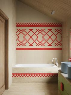 a bathroom with red and white tiles on the wall next to a bathtub in front of a window