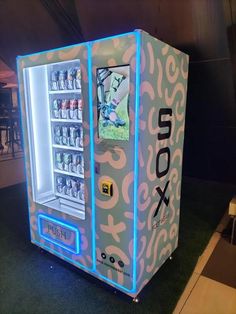 a vending machine is lit up with neon lights and an image of a football player on it