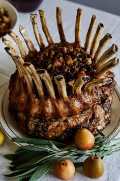 a large piece of meat sitting on top of a plate next to fruit and vegetables