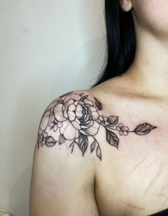 a woman with a flower tattoo on her chest